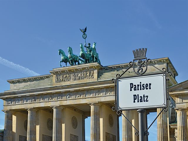 Brandenburger Tor mit Quadriga und Pariser Platz-Schild in Berlin.